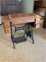 Antique Singer sewing machine with oak cabinet