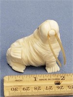 2" fossilized ivory carving of a walrus with inset