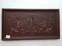 Mahogany wall hanging with raised relief.