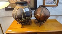 TWO RAWHIDE HUMARA TERRA POTS WITH METAL STANDS
