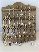 Collection of souvenir spoons on display rack