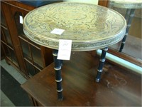 Embossed round Oriental brass table.