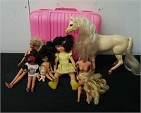 Plastic case with vintage barbies, dolls, and a