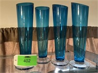Four blue vases