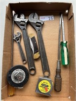 Pipe wrenches, tape measure, screwdrivers