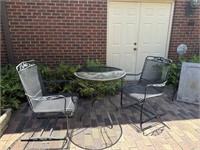 Wrought iron outdoor table and two bouncy chairs