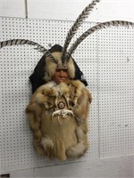 Native American decorated with feathers beaded