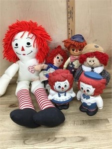 Box of Raggedy Ann dolls and plastic figures