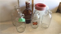 Whiskey jugs & plastic pitcher.