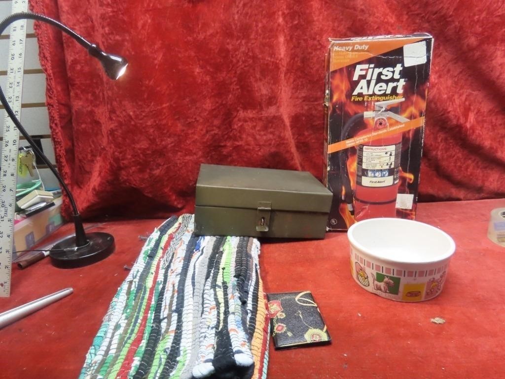 New fire extinguisher, rug, metal box, food dish.