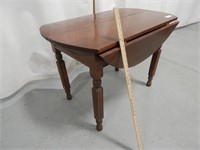 Drop leaf table; approx. 40" diam with leaves up