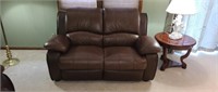 63 in leather loveseat, has small 2 in x 2 in