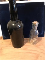 Two bottles - Clear one is an old pure milk bottle