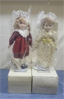 Avon porcelain dolls with stands. NIB. Some water
