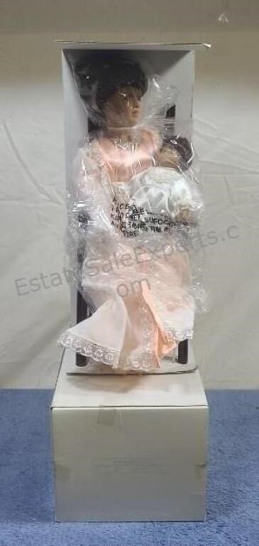 Avon porcelain doll with stand. NIB. Some water