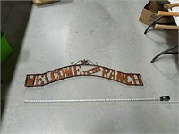 "Welcome to the ranch" sheet metal wall hanging.