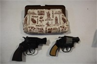 2 pistol cap guns with Hawaii handbag containing