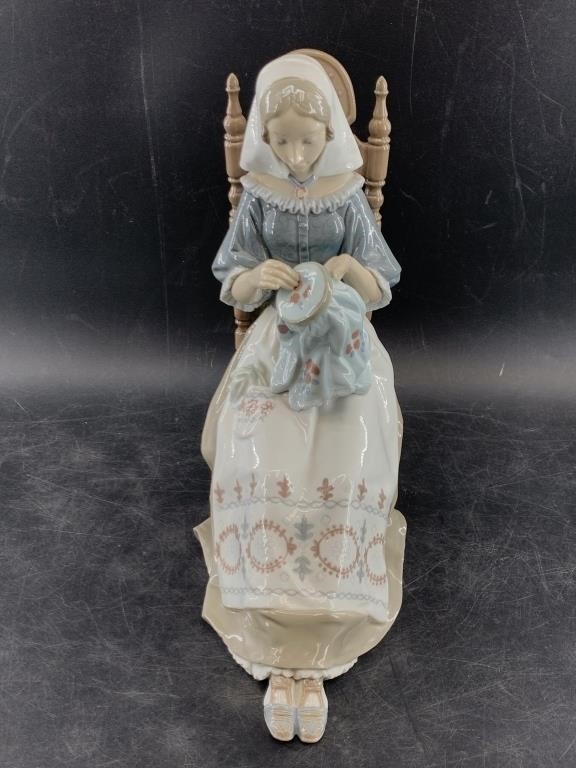 Large Lladro figurine of a woman doing needlepoint