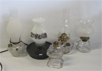 Lot of antique oil lamps and chimneys of various
