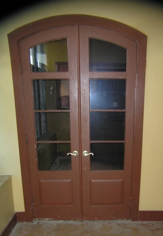 Pair of elegant 8 pane curved top hard wood doors