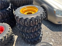 (4) 10-16.5 Skid Steer Tires On Yellow Wheels