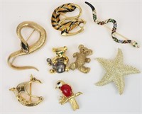 (8) FIGURAL BROOCHES
