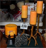 Assorted candleholders and candles.