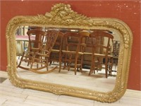 Torch Crowned Gilt Framed Beveled Mirror.