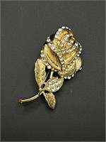 Gold toned rose and clear stone brooch