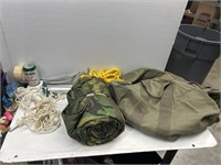 Army bag with rope and rolled up sleeping bag