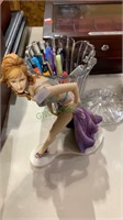 Glass candy jar with ink pens, lady model with a