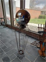 Gazing ball yard art on metal stand