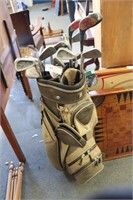 Golf bag with assorted golf clubs.