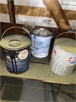 3 open containers of paint