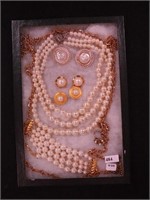 Container of faux pearl jewelry including