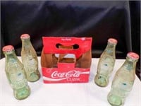 Vintage Centennial Coca Cola bottles with holder