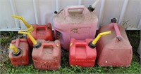 6 various size gas cans.