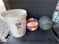 Bucket of baseballs, a basketball and a volleyball