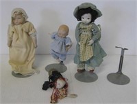 (4) Antique porcelain dolls. Three have stands.