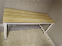 Wood table with metal base.