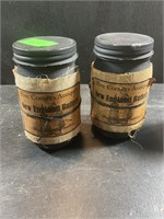 Two candles in jars with lids