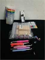 Dry erase markers, paint brushes and cups,