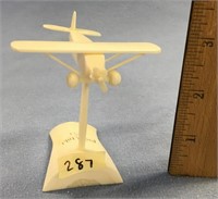 3" propellered plane carved out of ivory, mounted