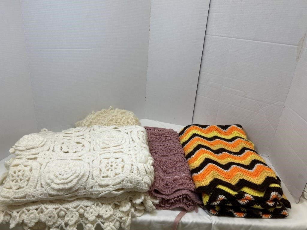 1 table cloth, 2 blankets, 1 knitted vest, bin