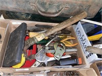 assorted tools including hammer pliers branches