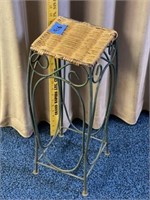 Small wrought iron table with wicker top
