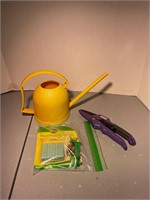 watering can plant food spikes and pruner