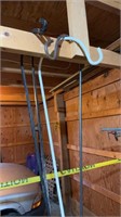Four metal shepherd hooks hanging in the garage