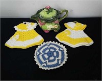 Decorative teapot, crocheted dress covers and hot