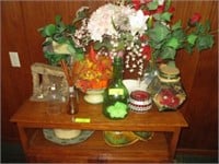 All flowers and items on cabinet; flowers on wall